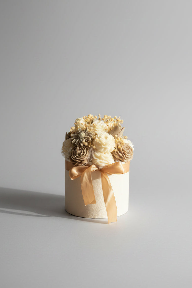 A beautiful collection of brown and white candle flowers in a velvet pot.
