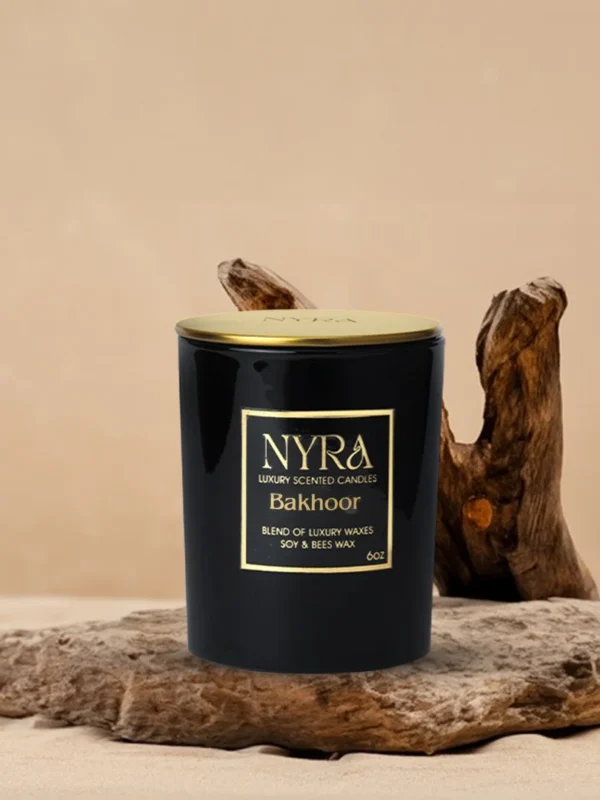 a black container with gold label on a piece of wood