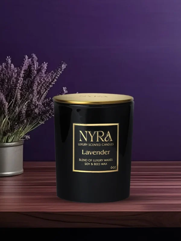 a black container with gold label next to a pot of lavender