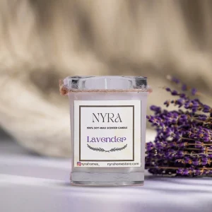 a candle and lavender flowers