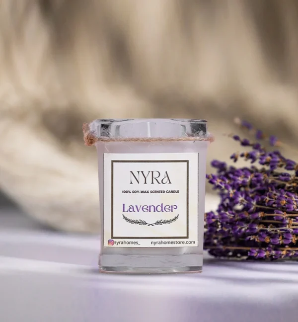 a candle and lavender flowers