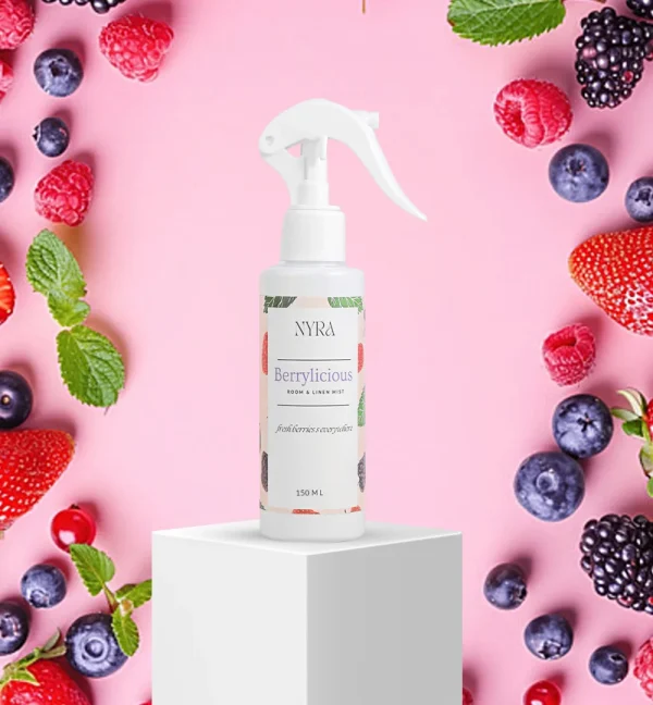 a spray bottle on a white cube surrounded by berries