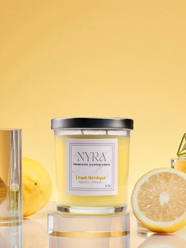a candle in a glass jar next to lemons