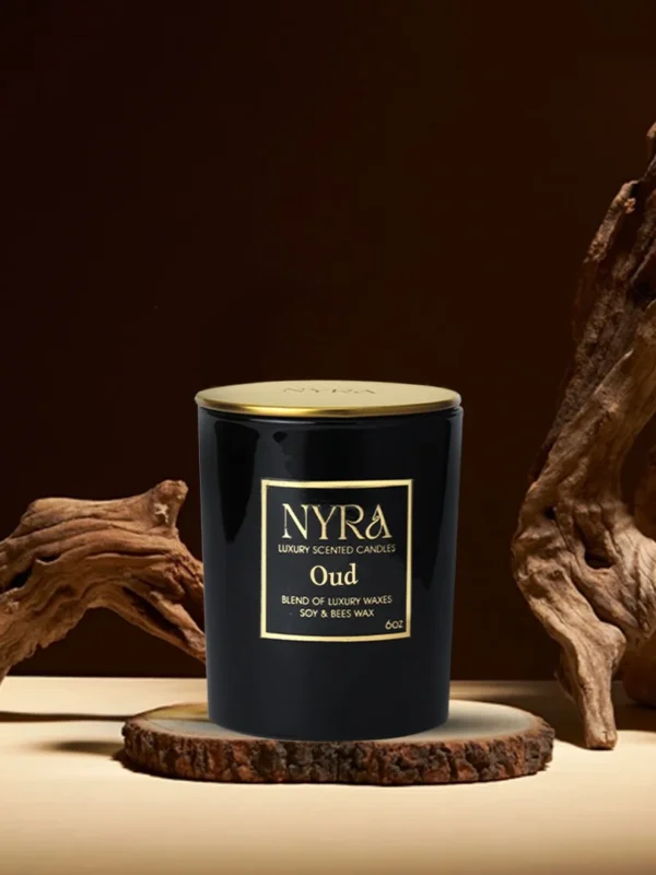 a black candle on a wood stand
