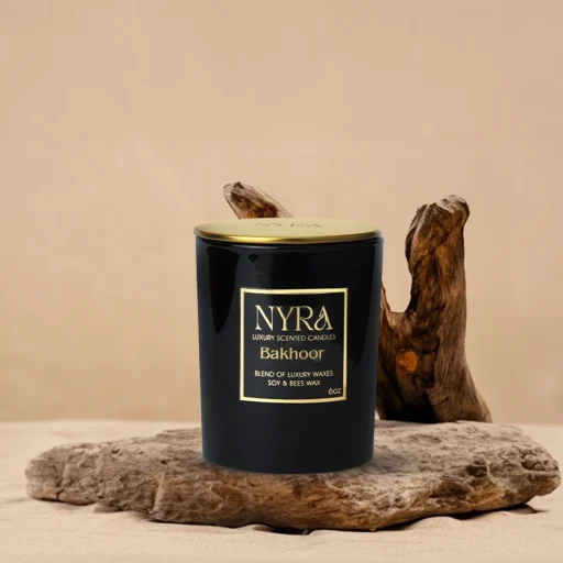 a black container with gold label on a piece of wood